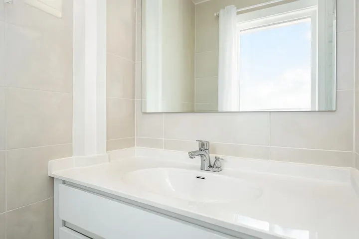 Multifamily bathroom faucet install on vanity
